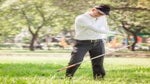 An angry golfer throws a club.